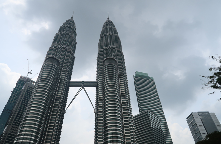 a tall buildings with Petronas Towers over them