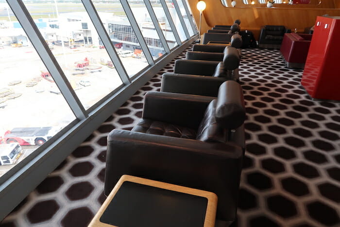 a row of chairs in a room with windows