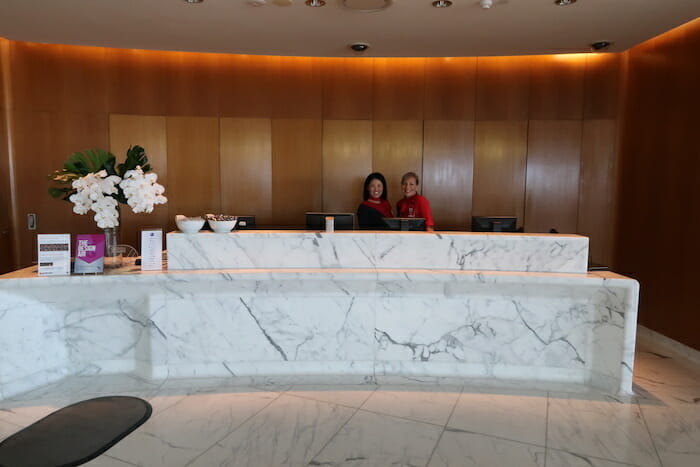 a couple of women standing behind a marble counter