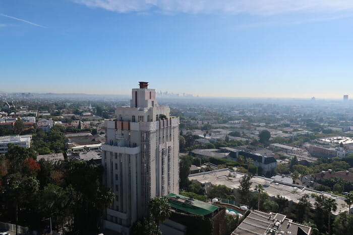 a tall building with trees and buildings in the background