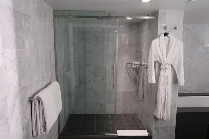 a shower with a glass door and a glass door