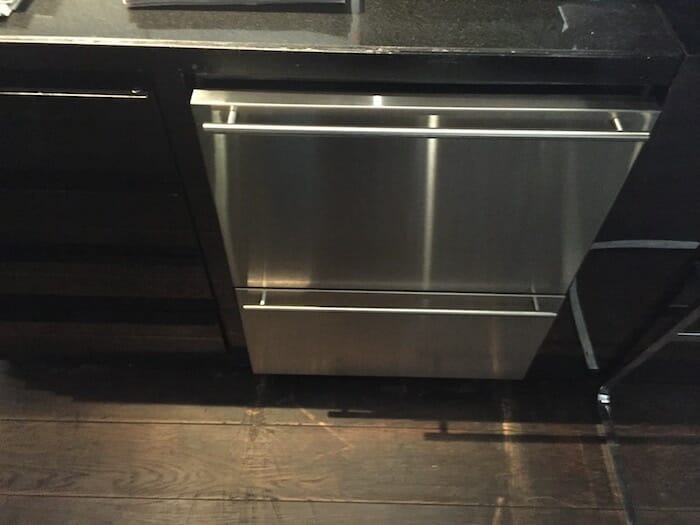 a stainless steel dishwasher under a counter