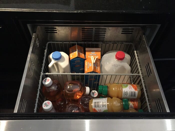 a shelf full of drinks and juices