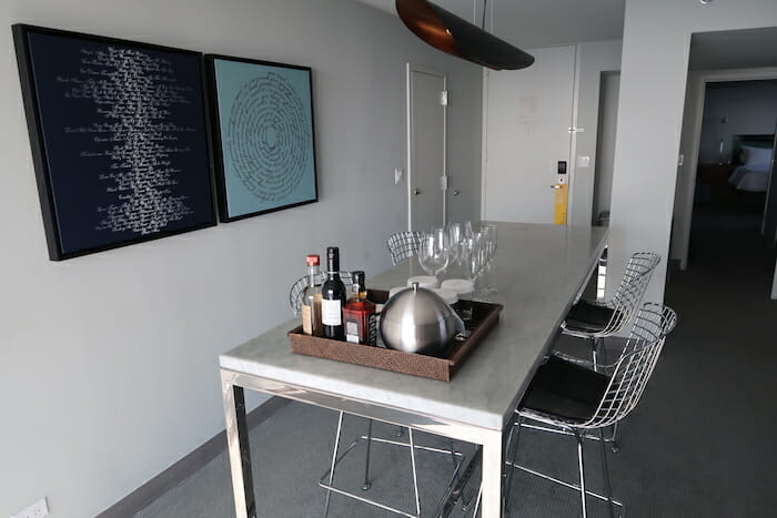 a table with chairs and a tray of wine glasses