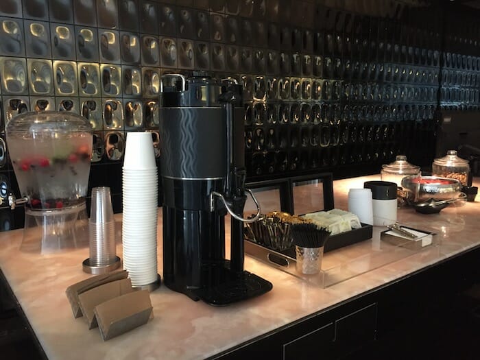 a coffee machine and cups on a counter