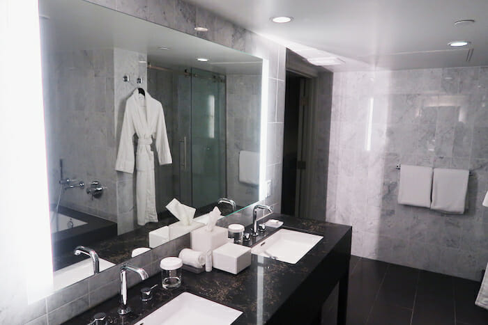 a bathroom with a large mirror and a bathrobe