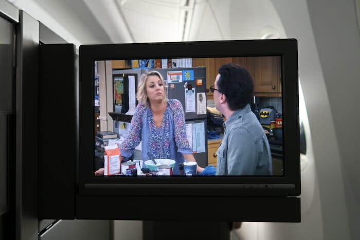 a tv screen with a woman and a man in the kitchen