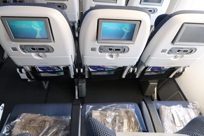 a row of seats with monitors