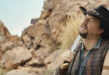 a man in a cowboy hat holding a knife