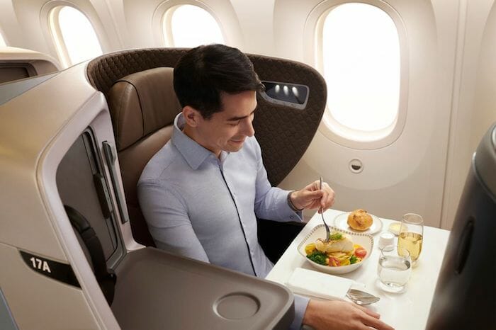 a man eating a meal on an airplane