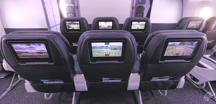 a row of seats with a television on the back