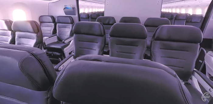 a row of black seats in an airplane