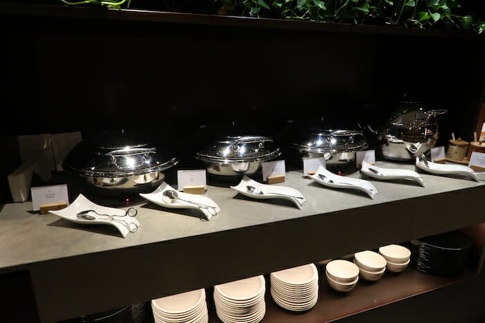 a group of silver bowls and plates on a counter