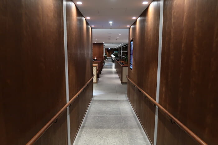 a hallway with wood walls and a railing