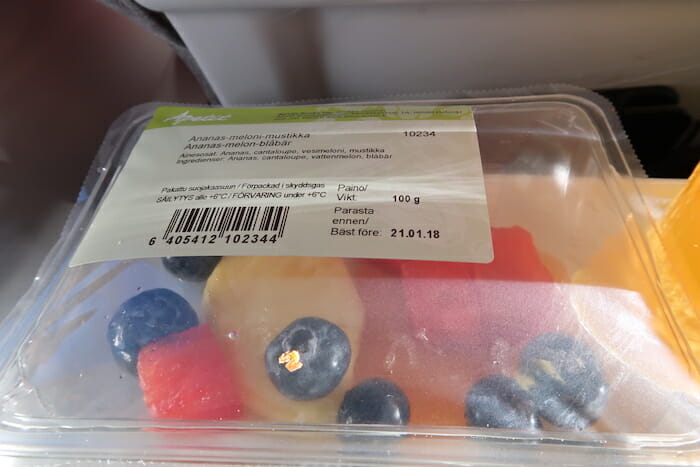 a plastic container with fruit in it