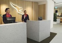 two women standing behind a desk