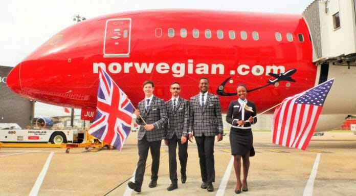 a group of people holding flags in front of a red airplane