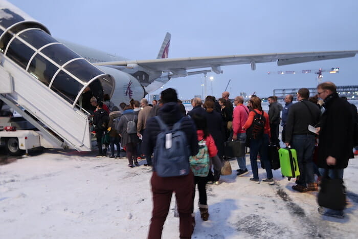 a group of people boarding an airplane