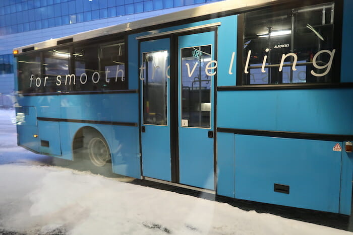 a blue bus with white text on it