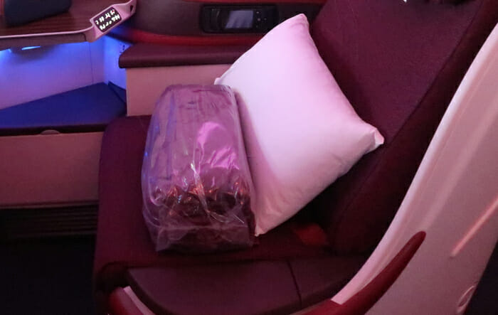 a pillow and a plastic bag on a seat