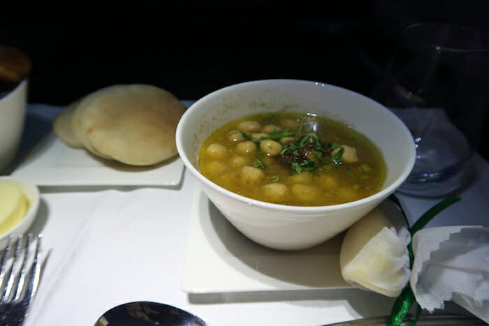 a bowl of soup and bread on a plate