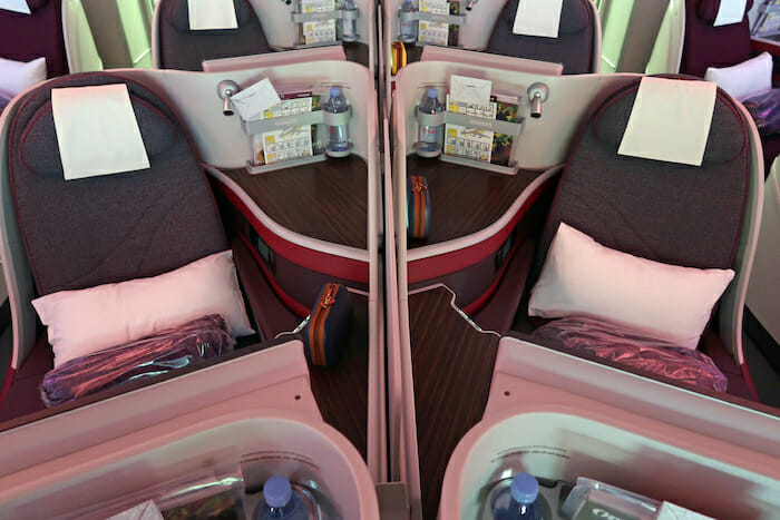 a mirror image of a row of seats with drinks and a couple of objects on the side