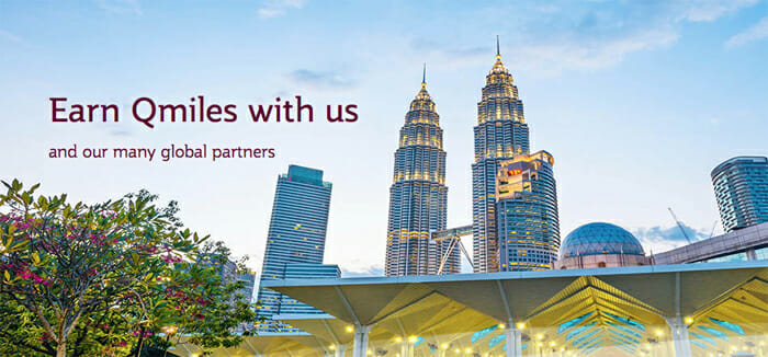 a group of tall buildings with a roof with Petronas Towers in the background