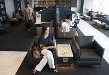 a woman sitting in a chair in an airport lounge