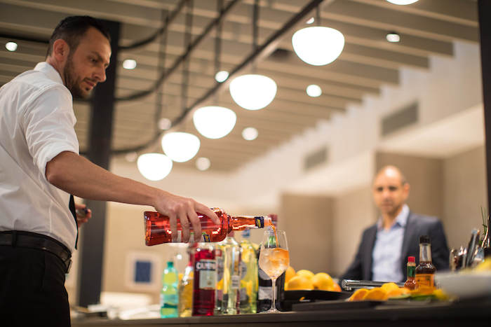 a man pouring a drink into a glass