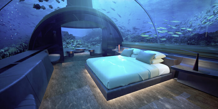 a bed in a room with fish in the water