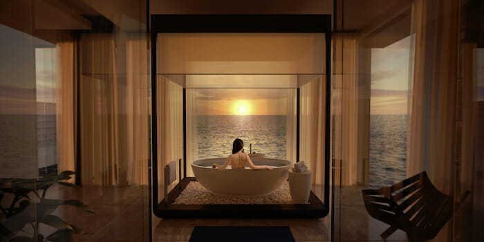 a woman in a bathtub with a view of the ocean