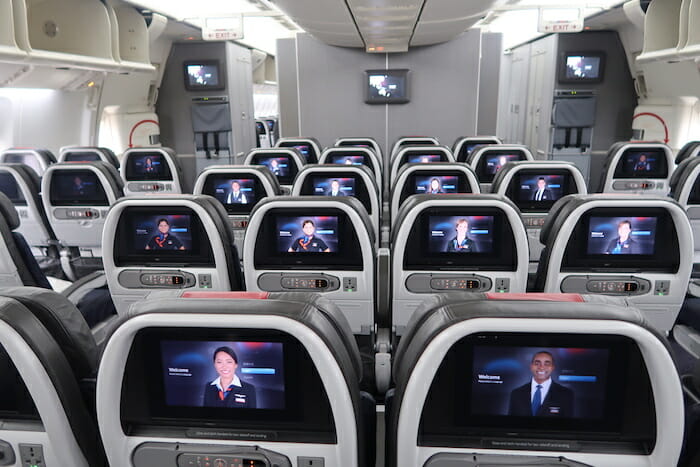 rows of seats with monitors on the side