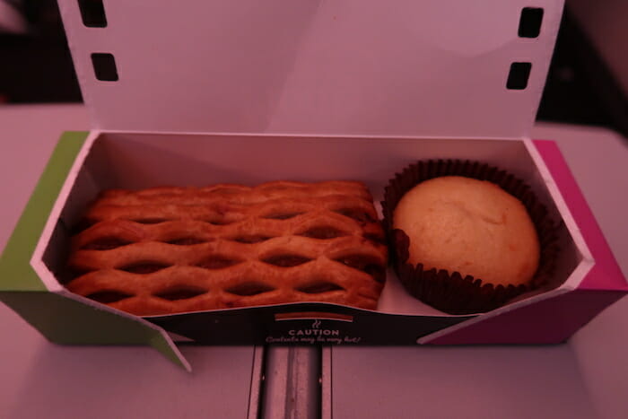 a box of pastries and a muffin