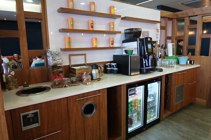 a coffee machine and refrigerator in a room