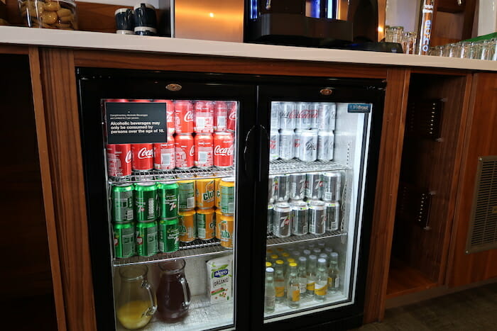 a refrigerator with cans of soda and other beverages