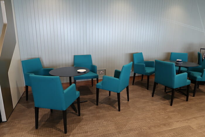 a group of blue chairs around a table