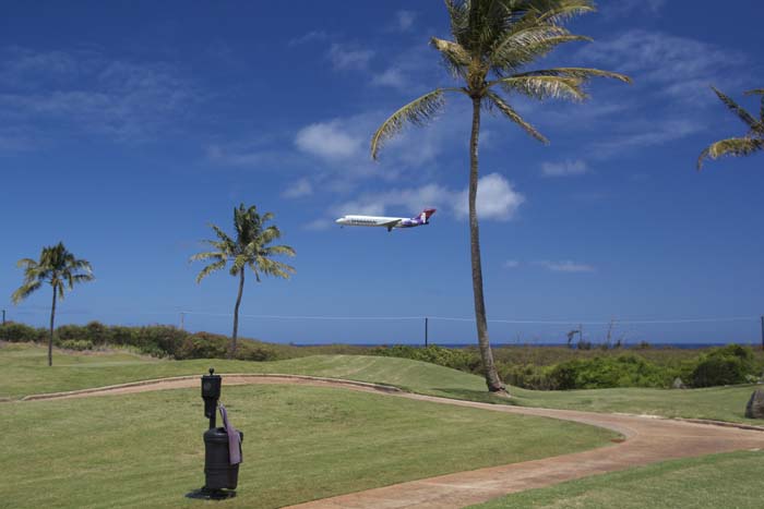 a plane flying over a golf course