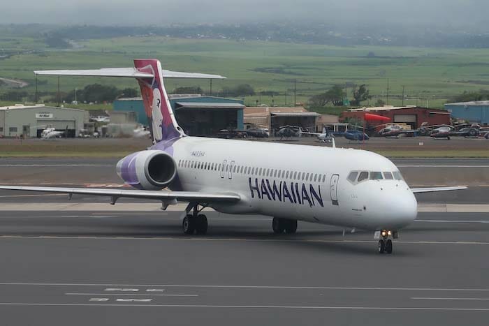 a white airplane on a runway