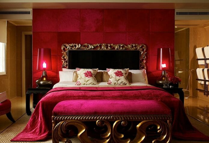 a bed with a red and gold headboard