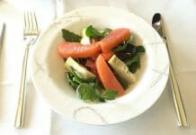 a plate of salad with salmon and vegetables