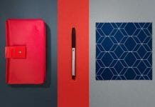a red case and a pen next to a blue cloth and a pen