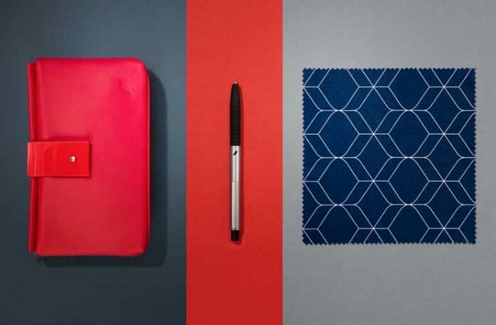 a red case and a pen next to a blue cloth and a pen