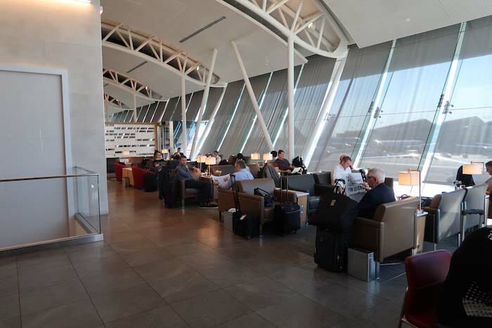 people sitting in a lounge area with luggage