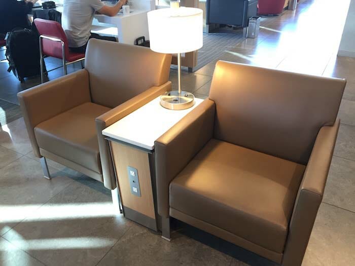 a pair of brown chairs with a lamp on top of each other