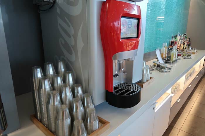 a machine with a screen and many cups on a counter