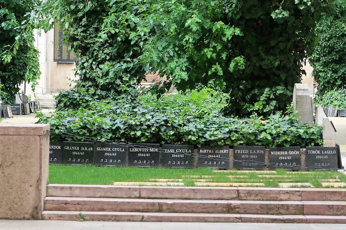 a row of black containers with white text on them