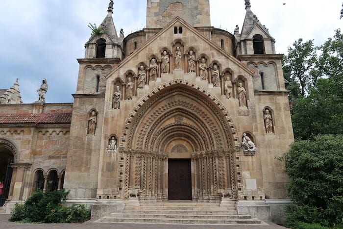 a stone building with statues on the front