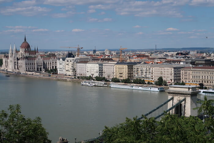 a river with a bridge and buildings