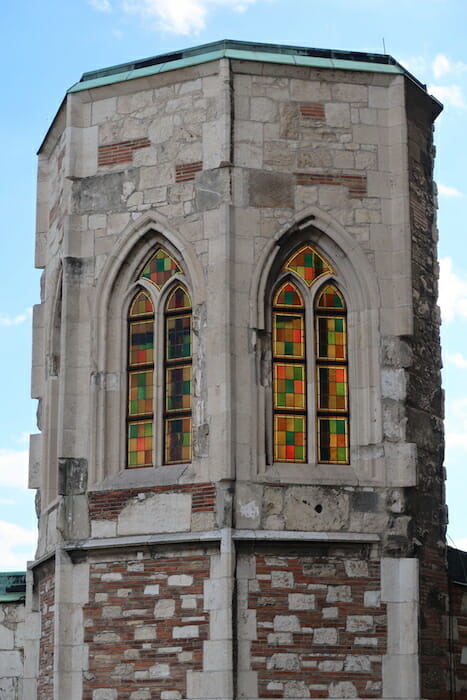 a stone tower with stained glass windows