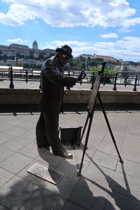 a statue of a man painting